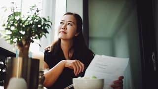 person holding document looking off.jpg