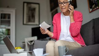 senior holding check and talking on phone.jpg