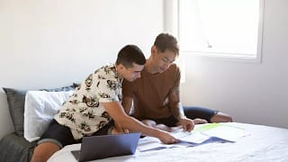two people sitting on bed with paperwork and .width AejXpPB.jpg