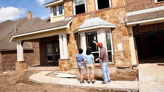 two women and builder at new construction hom.width ozvCZIy.jpg