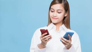 woman looking at red phone and blue phone AyA.width .jpg