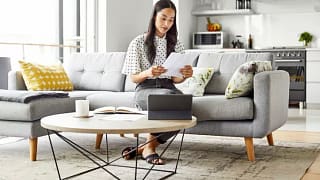 woman on couch with paperwork yVwyVDh.width .jpg