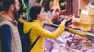 Couple using credit card at farmers market Rc.width .jpg