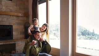 Young family bundled up in warm clothes by a .width tViqgX.jpg