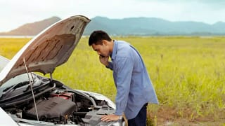 man checking car engine side of road.width .jpg