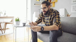 man holding phone and credit card GXOd.width .jpg