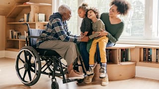 older lady in wheelchair with her famly.jpg