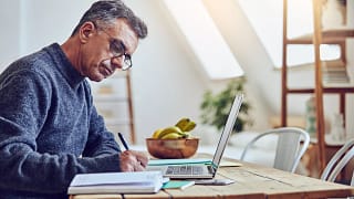 older man at laptop taking notes gettyimages .jpg