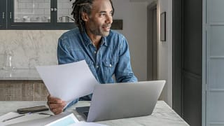 person at kitchen counter with laptop oDMjYzA.width .jpg
