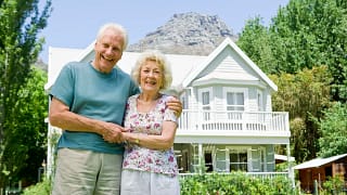 senior couple outside of larger home gettyimages .jpg