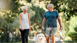 senior couple walking dog gettyimages .jpg