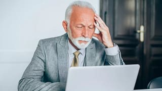 senior man suit laptop stress gettyimages .jpg