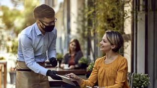 waiter and woman at restaurant.width .jpg