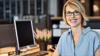 woman s smiling desk gettyimages .jpg