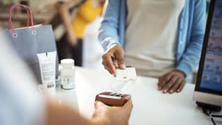 woman paying with credit card at pharmacy tKE.width .jpg