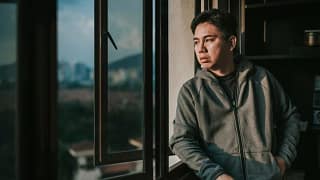 worried person looking out window zdzwcc.width .jpg