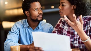 Couple dismayed by document in hands zNKqbht.width .jpg