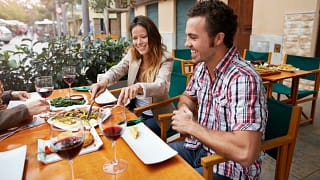 Couple sharing food at a european style resta.width VdwCA.jpg