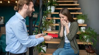 Man hands young girl a gift in an envelope zh.width .jpg