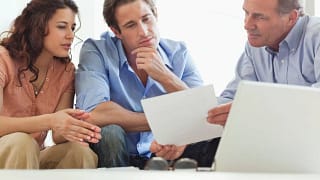 Mature man going over paperwork with young co.width iTNbwX.jpg