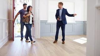 couple viewing house with realtor.width .jpg