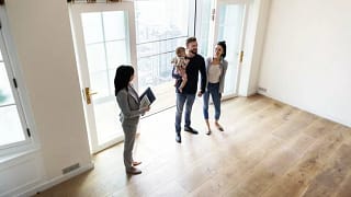 family viewing new house with realtor.width .jpg