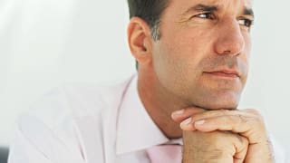 getty images mature man thinking with chin resting on hands planning retirement.jpeg