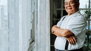getty smiling senior with arms crossed.jpg
