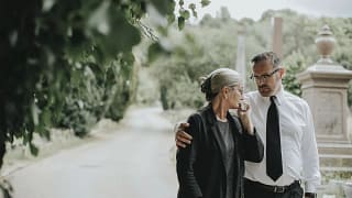man comforting woman at funeral.width .jpg