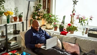 man on couch with laptop and credit card wnWu.width .jpg