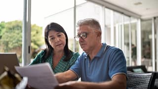 middle aged couple looking at document.jpg