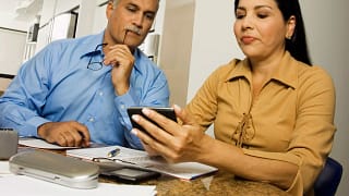 middle aged couple with calculator.jpg
