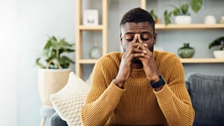 person sitting on a couch feeling worried.jpg
