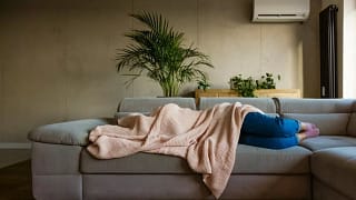 sick person on couch under blanket vzOhDg.width .jpg