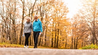 two older people walking in a park.jpg