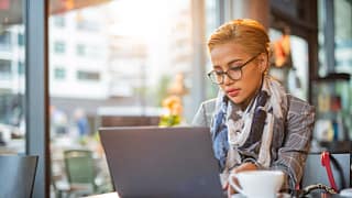 woman s laptop serious at coffee bar gettyimages .jpg