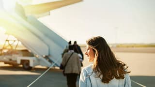 woman boarding plane outside.width .jpg