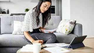 woman on couch with papers and tablet hBtEvpP.width .jpg