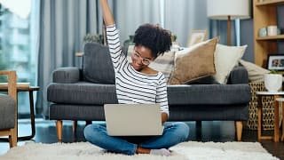 woman on laptop celebrating rLixvEH.width .jpg
