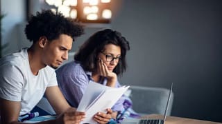 worried couple with bills and laptop.width .jpg