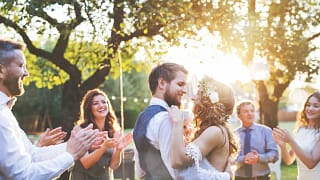 young bride and groom hugging in a backyard s.width .jpg