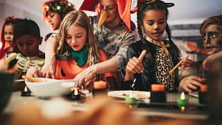 Adults and kids doing crafts at a halloween p.width SWBpjhZ.jpg