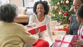 Family passing around Christmas gifts APo.width .jpg