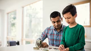 Father and son counting money at home zJVwCZ.width .jpg