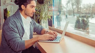 Man on laptop in cafe ateKKd.width .jpg