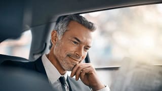 Man sitting in car looking at newspaper wEK.width .jpg