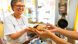 Mature woman selling a box of baked goods jJi.width .jpg