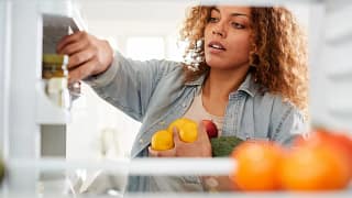 Woman looking in refrigerator.width .jpg