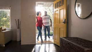 couple walking in front door MIKwg.width .jpg