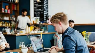 man on laptop in cafe AhCu.width .jpg
